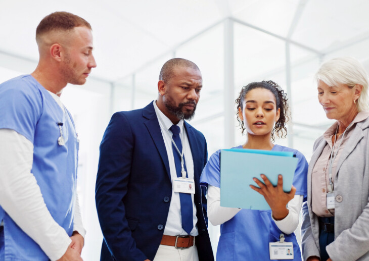 Two doctors and two healthcare leaders in discussion.