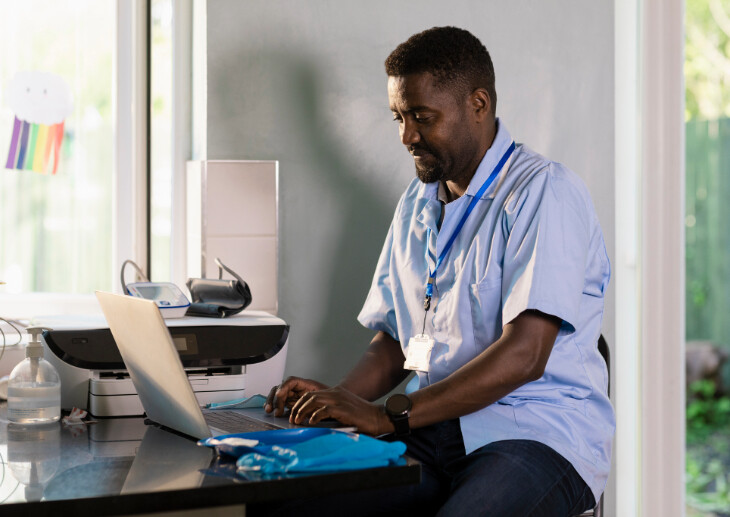 Doctor on laptop.