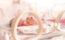 A close up of a hospital incubator with a premature baby lying inside with a nasal oxygen tube to illustrate the NHS England announcement of an immunisation programme to protect premature babies from RSV with single-injection nirsevimab