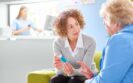 Healthcare professional discussing inhaler options with an older patient in a clinical setting to illustrate aligning patient-centred care and sustainability in inhaler choice