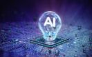 A glowing light bulb with AI in the centre, sitting on a microchip on a purple and blue circuit background to symbolise the rise of AI tools in infectious disease management presented at ESCMID