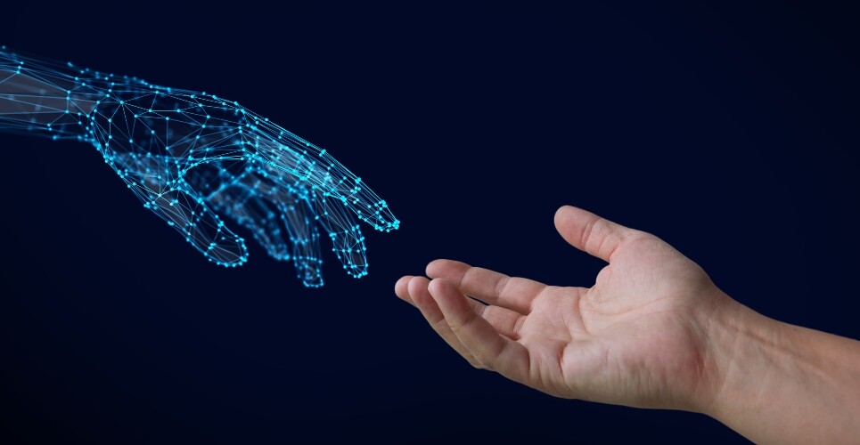 A human hand reaching out to touch a virtual hand composed of interconnected blue lines and glowing nodes to illustrate a new artificial intelligence policy statement from FIP and the need for responsible and ethical integration into pharmacy practice