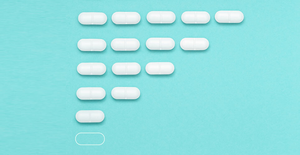 Five white pills on a blue background with four pills underneath and then three, two and one, followed by the outline of a pill to illustrate antidepressant deprescribing strategies