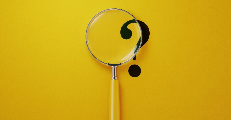 A black question mark on a yellow background with a yellow-handled magnifying glass over the top to illustrate new research identifying diagnosis delays and treatment gaps in psoriatic arthritis