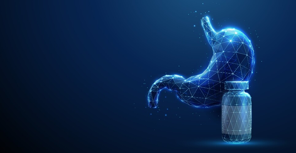 Abstract blue human stomach next to a medicine bottle to illustrate the finding that long-term PPI use may not increase gastric cancer risk as previously thought