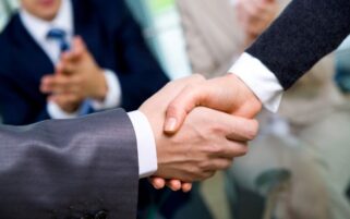 two hands agreeing on merger deal