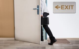 GPs may leave - man walking out door with exit sign on wall