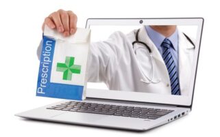 doctor reaching through laptop with bag of medicine