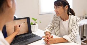 Woman views computer screen showing photo of skin assessment