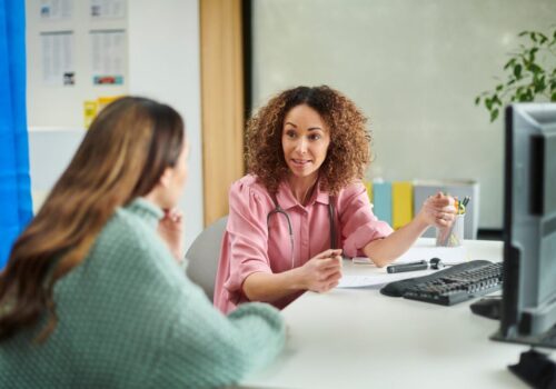 Doctor supervising a colleague in a consultation room