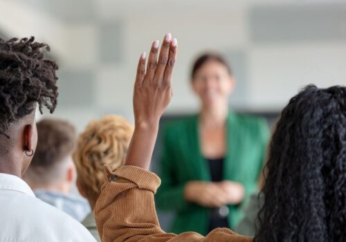Students raising their hand as physician associate courses that have been approved are revealed
