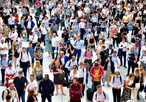 A crowd of people going back to work waiting for a train at Liverpool Street, London