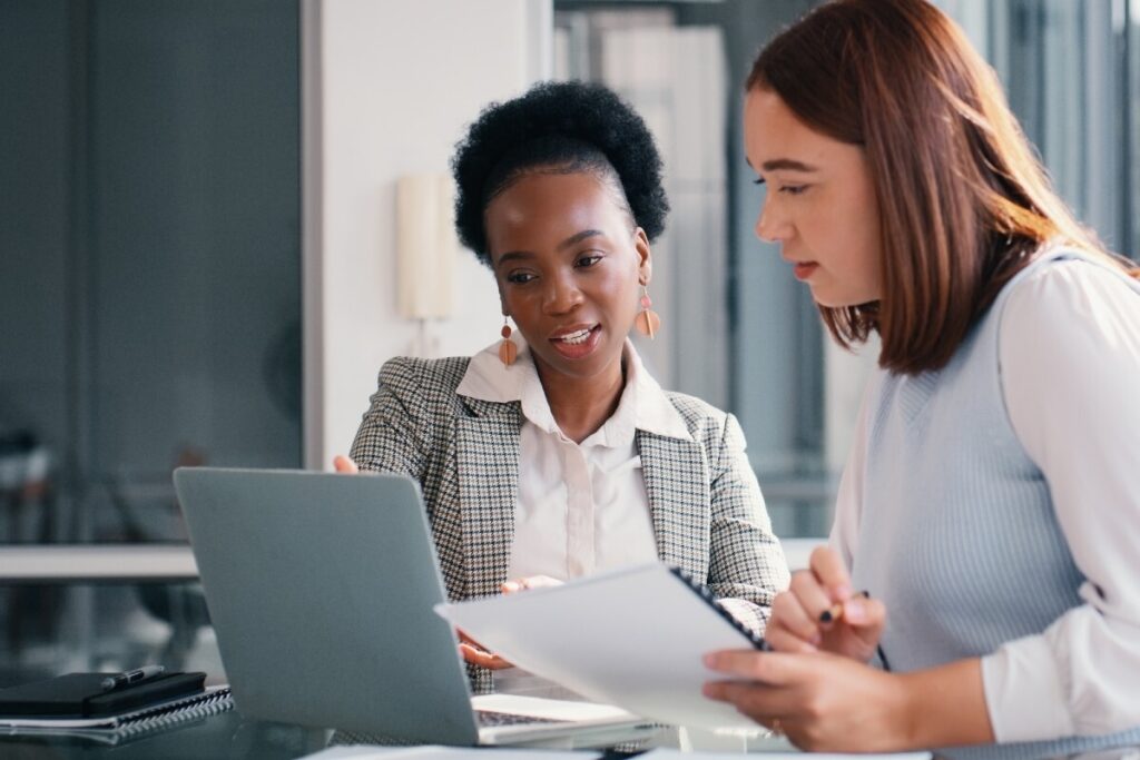 Two staff members assess GP practice systems