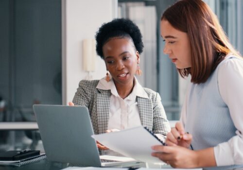 Two staff members assess GP practice systems