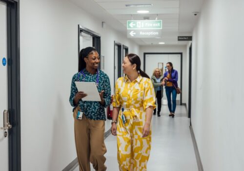 Healthcare Professionals Walking in Corridor