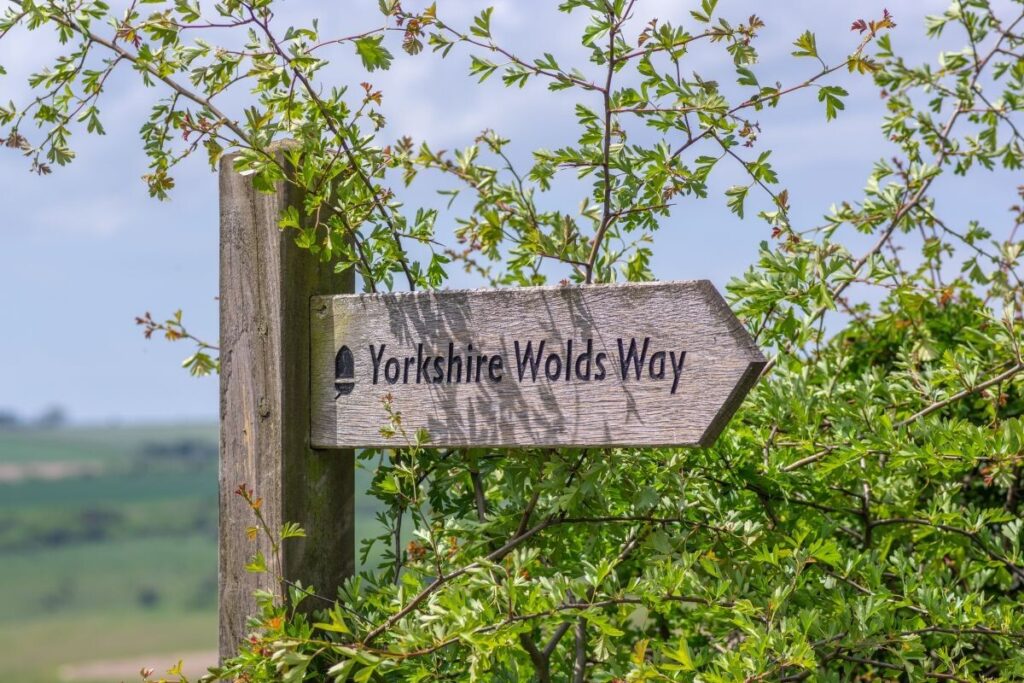 Wooden pathway sign marked Yorkshire Wolds