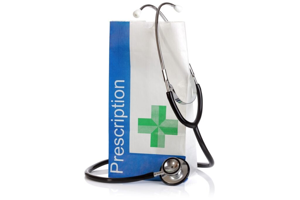 stethoscope wrapped round paper bag saying prescription