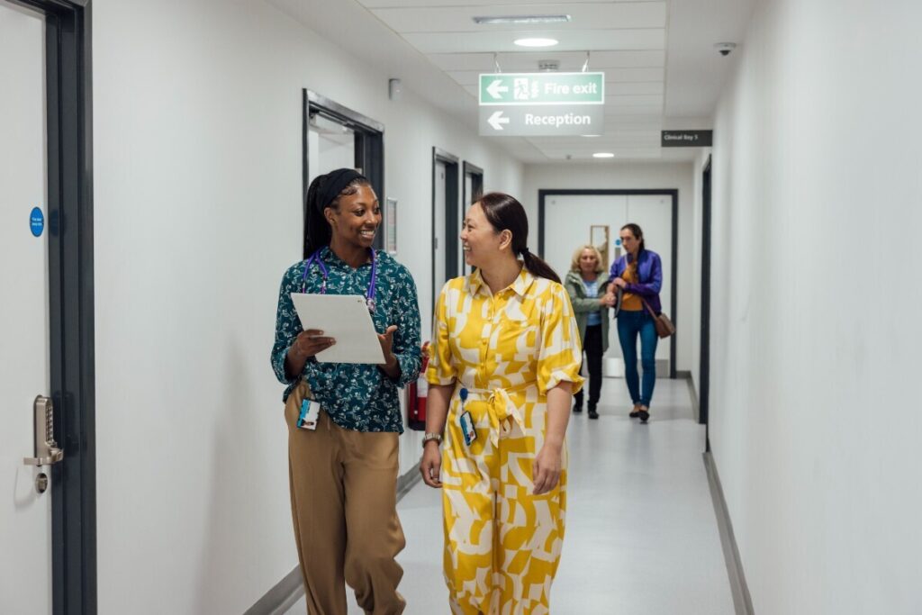 Healthcare Professionals Walking in Corridor