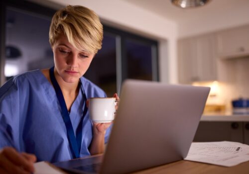 Doctor completing work on her laptop