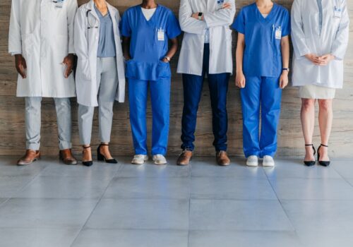 Team of professional, healthcare workers standing in the corridor