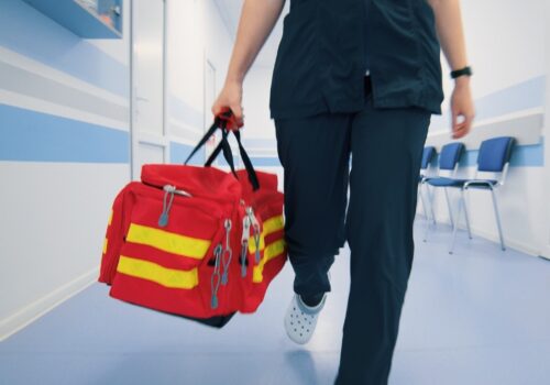 Paramedic Walking with Red Emergency Bag