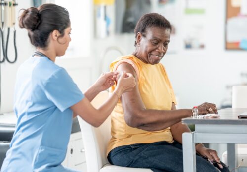 A doctor administering a vaccine to a patient.
