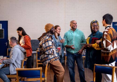 diverse community group laughing and chatting