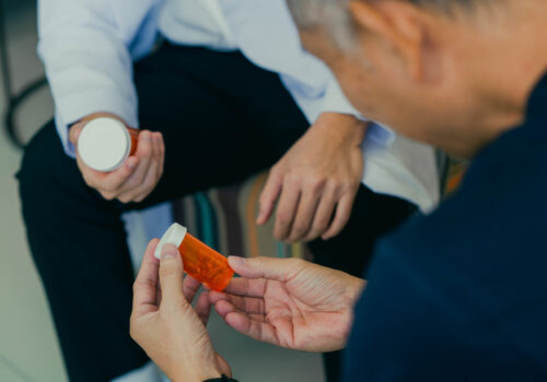 Doctor consulting patient about a prescription and discussing health treatment.
