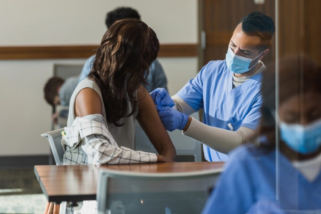 Healthcare worker delivers vaccine