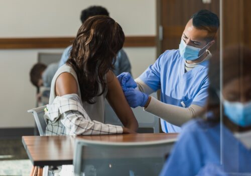 Healthcare worker delivers vaccine