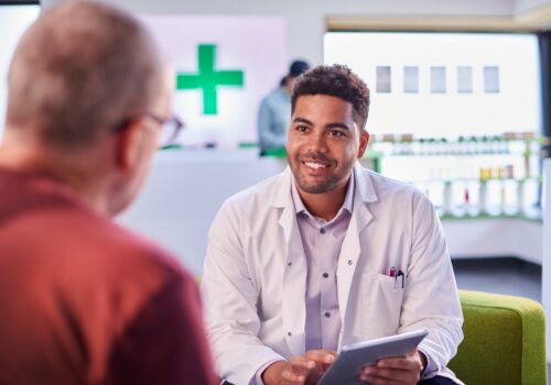 A pharmacist speaking with a patient.