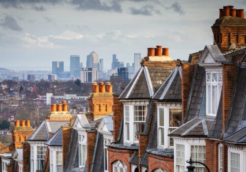 A photo of neighbourhood houses with the London skyline in the background.