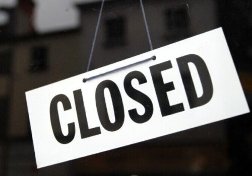 A sign on a window saying 'closed'