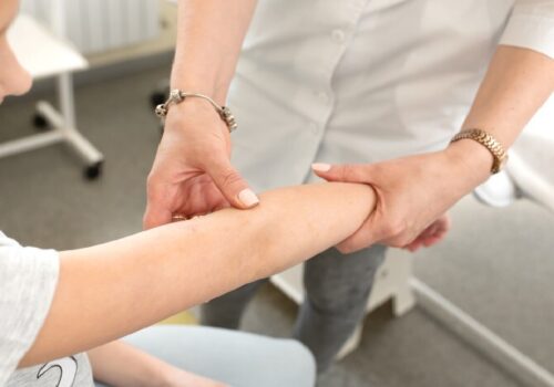 Clinician checking skin on arm
