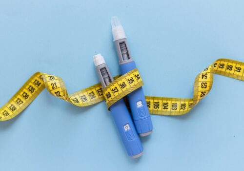 weight loss jabs and measuring tape