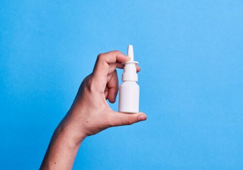 white nasal spray on blue background