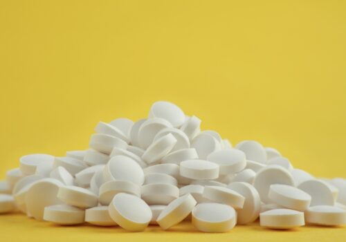 white tablets on yellow background