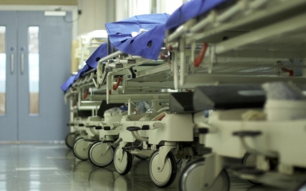 hospital beds/trolleys lined up in a hospital ward