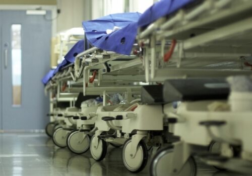 hospital beds/trolleys lined up in a hospital ward