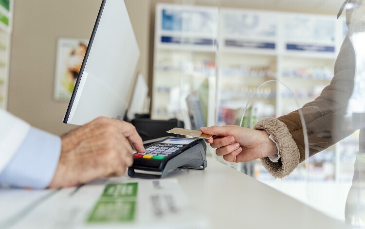 Someone paying with credit card in a pharmacy