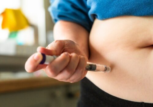Woman using injection to administer weight loss drug
