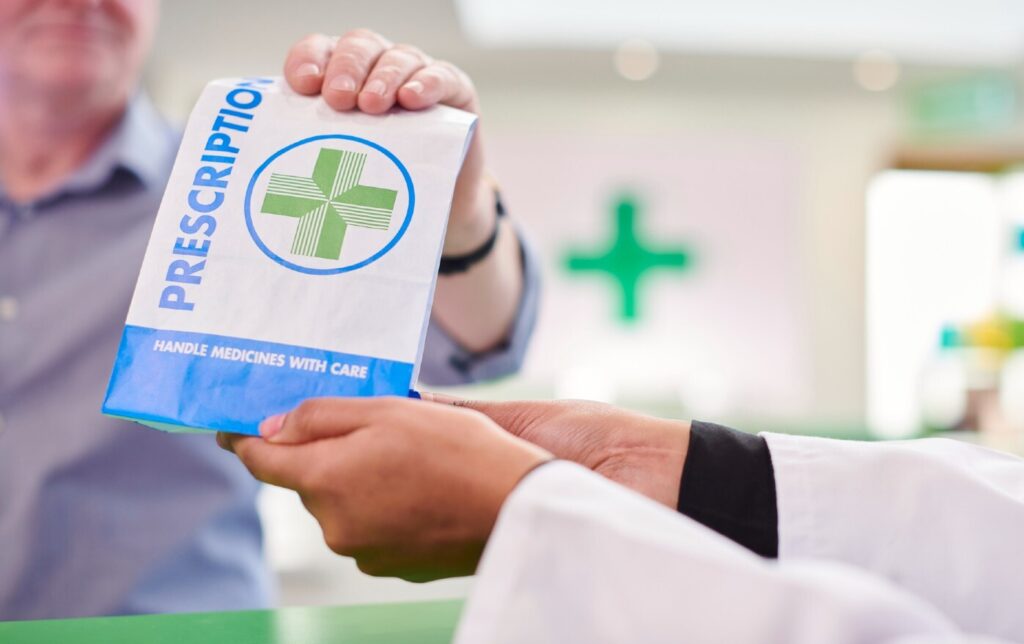 pharmacist handing over a prescription