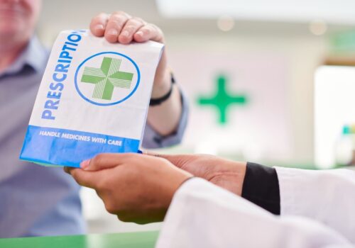 pharmacist handing over a prescription