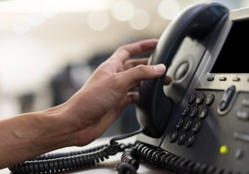 Person answering a landline phone