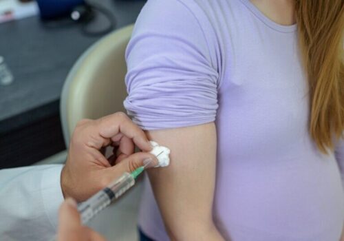 Pregnant woman receiving vaccination