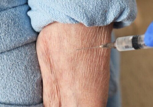 vaccination going into older person's arm