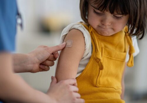 young child having vaccine