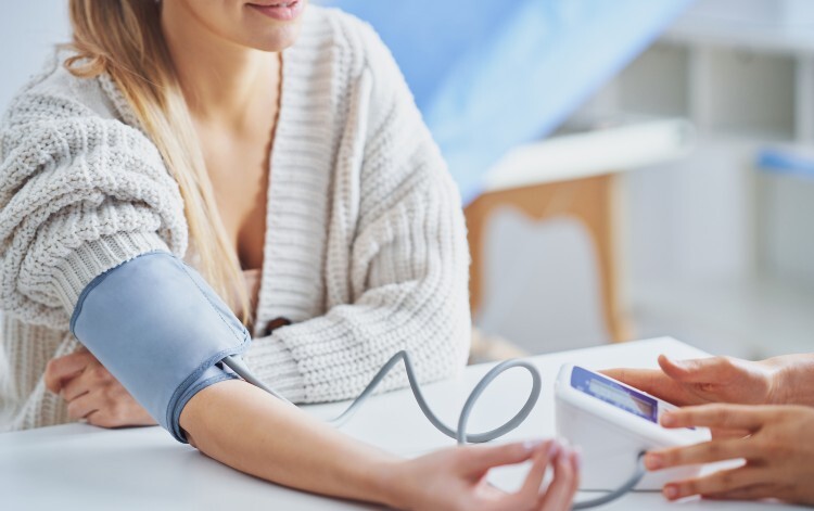 Woman having blood pressure check
