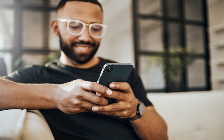 Man looking at the NHS App on his mobile phone