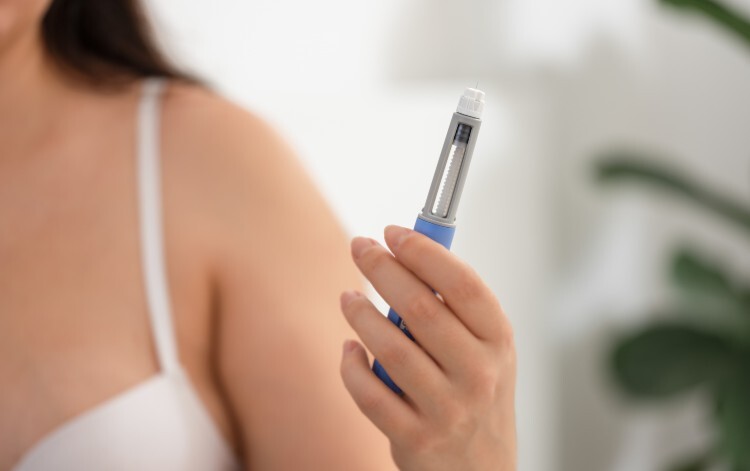 Woman holding weight loss injection